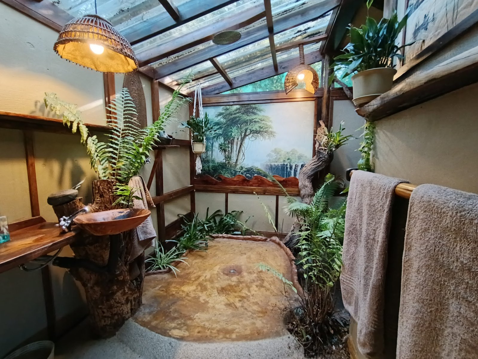Open-air bathroom with cast-concrete tub and driftwood sink